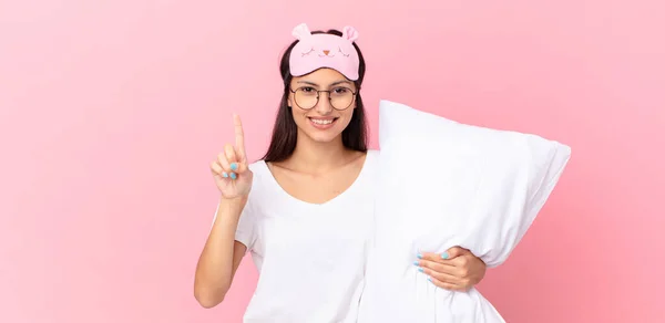 Hispanic Woman Wearing Pajamas Smiling Looking Friendly Showing Number One — Stok fotoğraf
