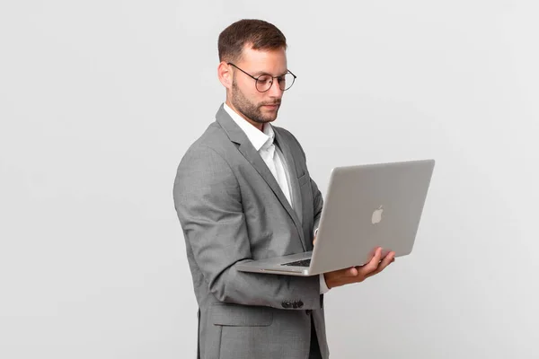 Przystojny Biznesmen Posiadania Laptopa — Zdjęcie stockowe