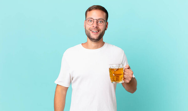 young handsome man drinking a pint of beer