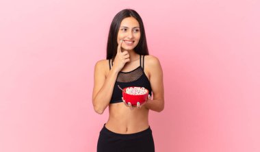 pretty hispanic woman with a diet breakfast bowl