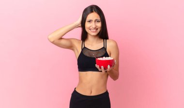pretty hispanic woman with a diet breakfast bowl