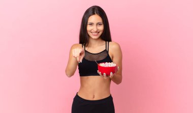 pretty hispanic woman with a diet breakfast bowl