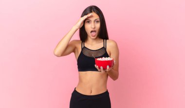 pretty hispanic woman with a diet breakfast bowl