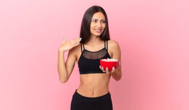 pretty hispanic woman with a diet breakfast bowl