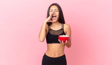 pretty hispanic woman with a diet breakfast bowl