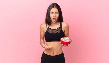 pretty hispanic woman with a diet breakfast bowl