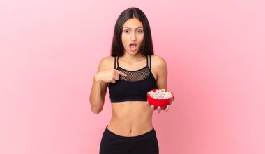 pretty hispanic woman with a diet breakfast bowl