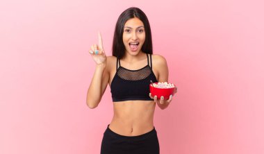 pretty hispanic woman with a diet breakfast bowl