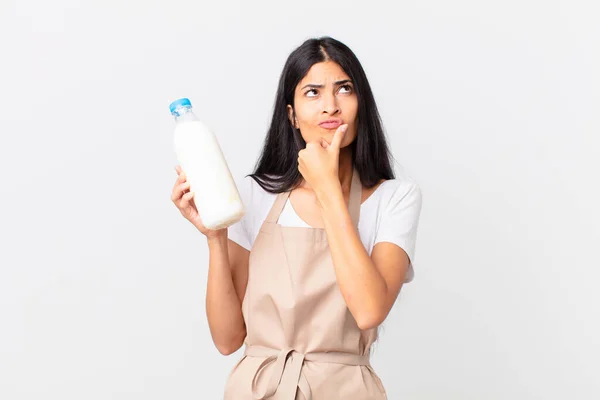 Pretty Hispanic Chef Woman Thinking Feeling Doubtful Confused Holding Milk — Stock Photo, Image