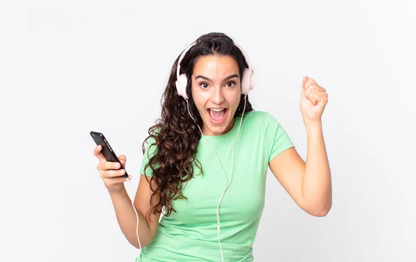 Pretty Hispanic Woman Feeling Shocked Laughing Celebrating Success Headphones Smartphone — Stock Photo, Image
