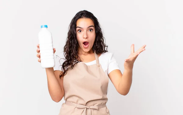 Hispanic Pretty Chef Woman Feeling Extremely Shocked Surprised Holding Milk — Stock Photo, Image