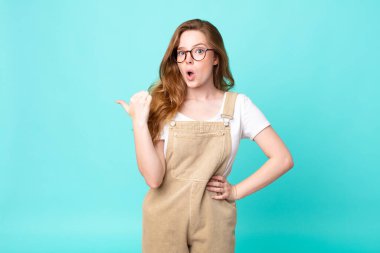 Güzel kızıl saçlı kadın inançsızlıktan şaşkın şaşkın bakıyor