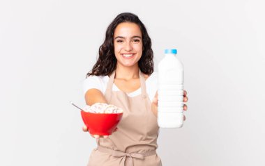 İspanyol güzel aşçı kadın elinde sütlü kahvaltı kasesi tutuyor.