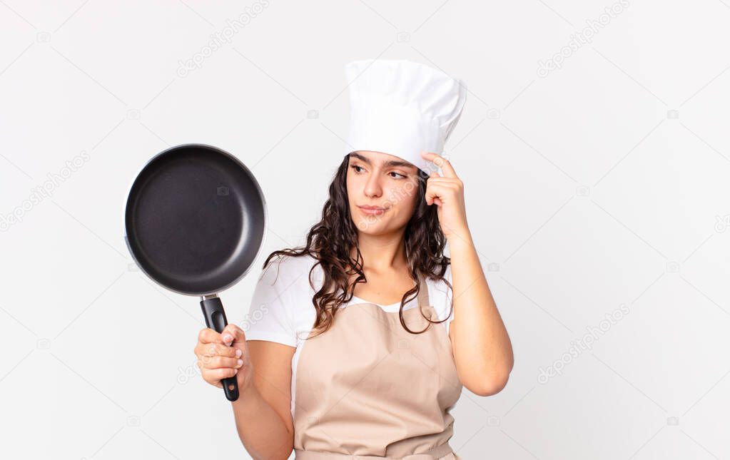 hispanic pretty chef woman holding a pan
