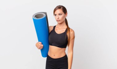 Güzel bir kadın üzgün, üzgün ya da kızgın hisseder ve bir tarafa bakar. yoga konsepti