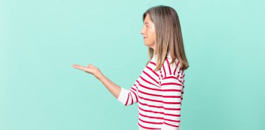 Profilde orta yaşlı güzel bir kadın hayal kuruyor, hayal kuruyor ya da hayal kuruyor.