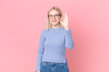 Sarışın, güzel bir kadın kendini mutlu hissediyor. Onayını veriyor.