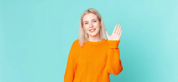 Blond Pretty Woman Smiling Happily Waving Hand Welcoming Greeting You — Stock Photo, Image