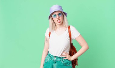 Sarışın, güzel bir kadın. İğrenmiş, rahatsız olmuş ve dili dışarı çıkmış. yaz konsepti