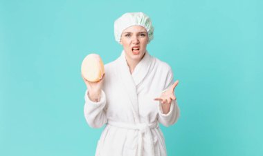 Sarışın, güzel bir kadın kızgın, sinirli, sinirli ve bornoz giyiyor.