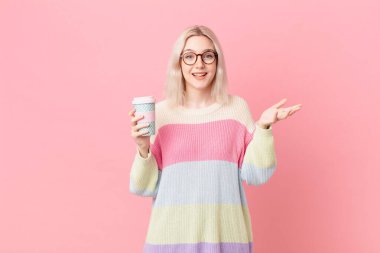 blond pretty woman feeling happy, surprised realizing a solution or idea. coffee concept