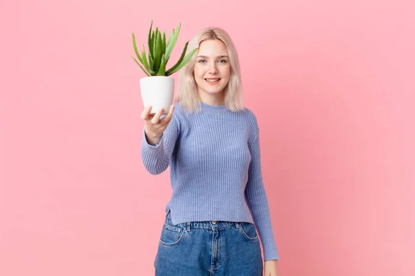 Blond Woman Holding Cactus —  Fotos de Stock