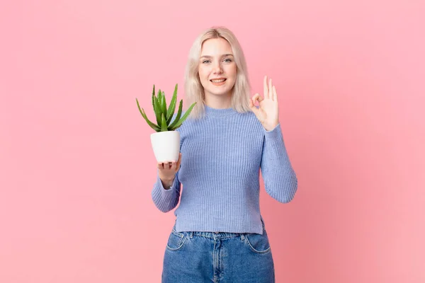 Blond Woman Holding Cactus — Zdjęcie stockowe