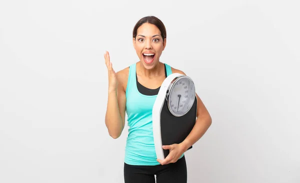 Young Hispanic Woman Feeling Happy Astonished Something Unbelievable Holding Scale — Stok fotoğraf