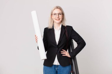 Sarışın, güzel bir kadın mutlu bir şekilde gülümsüyor, eli kalçasında ve kendinden emin. mimar konsepti