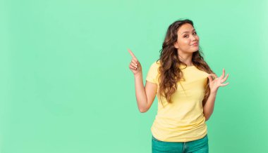 Genç, güzel bir kadın kibirli, başarılı, pozitif ve gururlu görünüyor ve fotokopi alanını işaret ediyor.