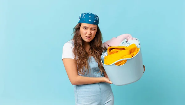 Young Pretty Woman Feeling Puzzled Confused Holding Wash Clothes Basket — Stock Photo, Image