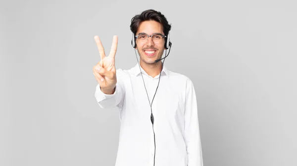 Young Hispanic Man Smiling Looking Friendly Showing Number Two Telemarketer — Stock Photo, Image