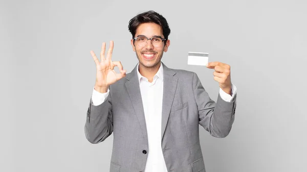 Young Hispanic Man Feeling Happy Showing Approval Okay Gesture Holding — Stock Photo, Image