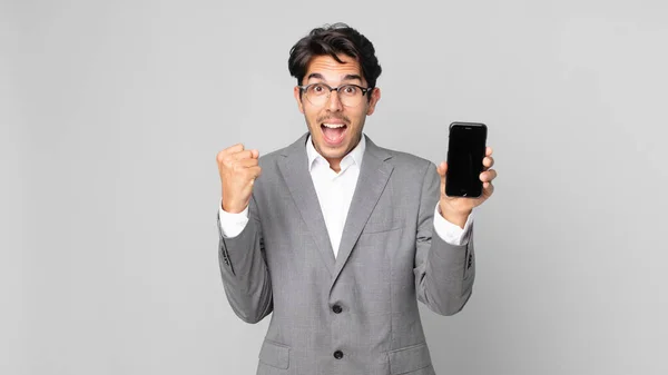 Young Hispanic Man Feeling Shocked Laughing Celebrating Success Holding Smartphone — Stock Photo, Image