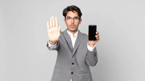 Young Hispanic Man Looking Serious Showing Open Palm Making Stop — Stock Photo, Image