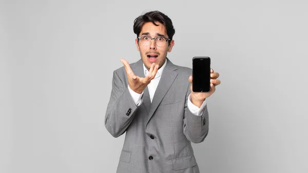 Young Hispanic Man Looking Desperate Frustrated Stressed Holding Smartphone — Stock Photo, Image