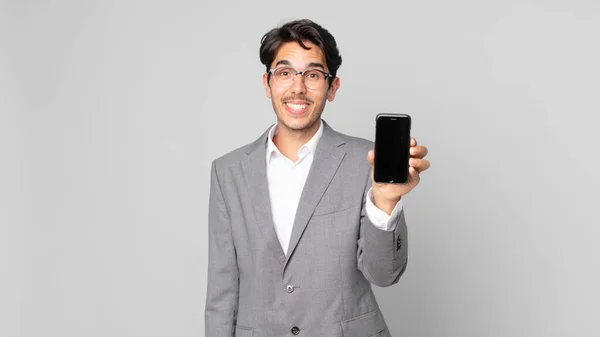 Young Hispanic Man Looking Happy Pleasantly Surprised Holding Smartphone — Stock Photo, Image