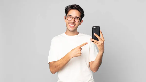 Young Hispanic Man Smiling Cheerfully Feeling Happy Pointing Side Holding — Stock Photo, Image