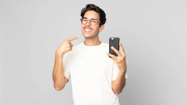 Young Hispanic Man Smiling Confidently Pointing Own Broad Smile Holding — Stock Photo, Image