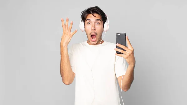 Jonge Spaanse Man Schreeuwen Met Handen Omhoog Lucht Met Koptelefoon — Stockfoto