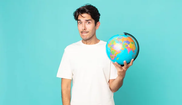 Young Hispanic Man Looking Puzzled Confused Holding World Globe Map — Stock Photo, Image