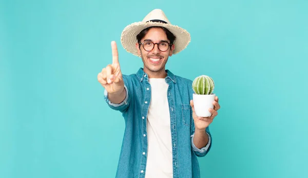 Young Hispanic Man Smiling Proudly Confidently Making Number One Holding — Stock Photo, Image