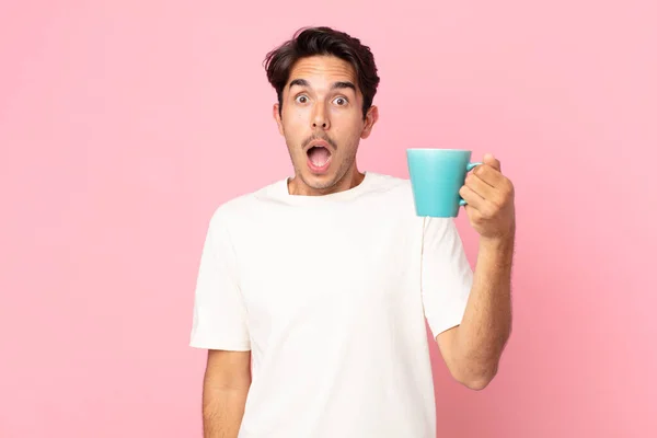 Jovem Hispânico Homem Olhando Muito Chocado Surpreso Segurando Uma Caneca — Fotografia de Stock