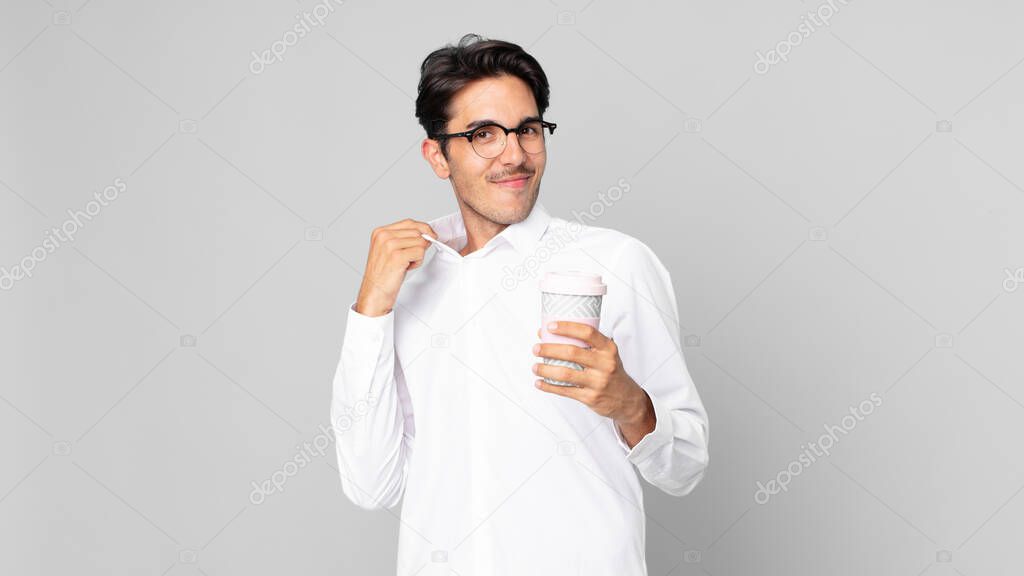 young hispanic man looking arrogant, successful, positive and proud and holding a take away coffee
