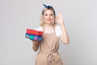 Genç, güzel, albino bir kadın kendini mutlu hissediyor. Onayını gösteriyor.