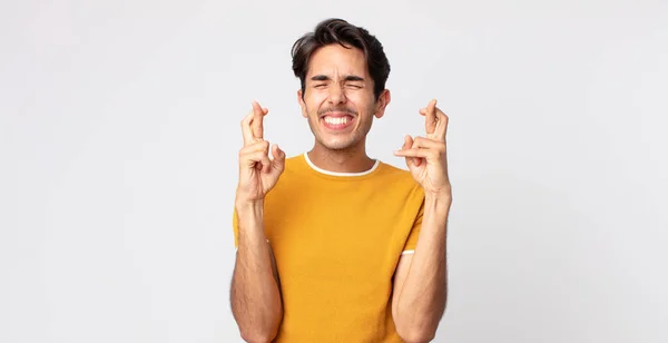 Hombre Guapo Hispano Sonriendo Ansiosamente Cruzando Ambos Dedos Sintiéndose Preocupado — Foto de Stock