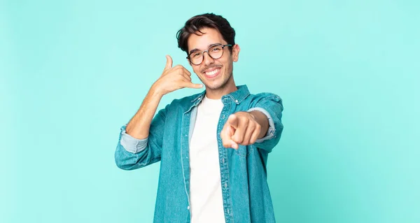 Hispanic Handsome Man Smiling Cheerfully Pointing Camera While Making Call — Stock Photo, Image