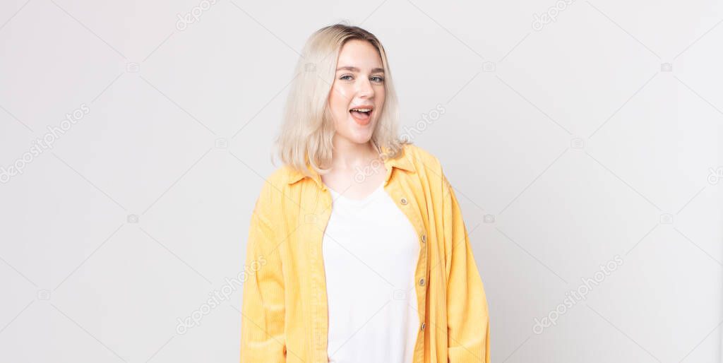pretty albino woman with a big, friendly, carefree smile, looking positive, relaxed and happy, chilling