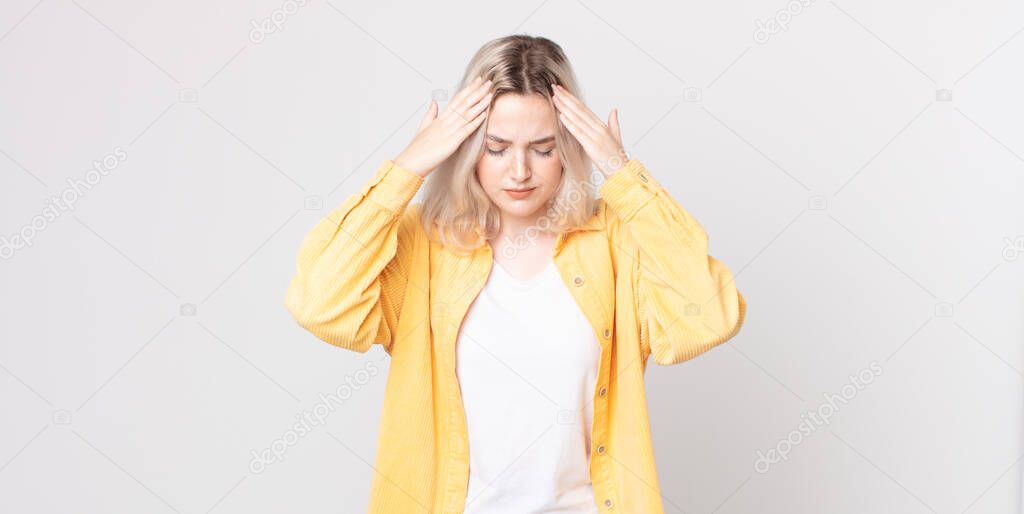 pretty albino woman looking stressed and frustrated, working under pressure with a headache and troubled with problems