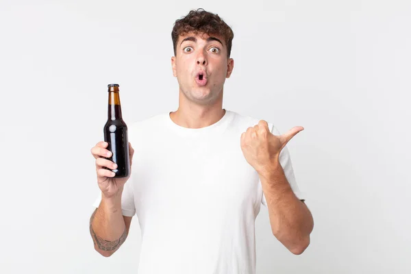 Young Handsome Man Looking Astonished Disbelief Holding Beer Bottle — Stock Photo, Image